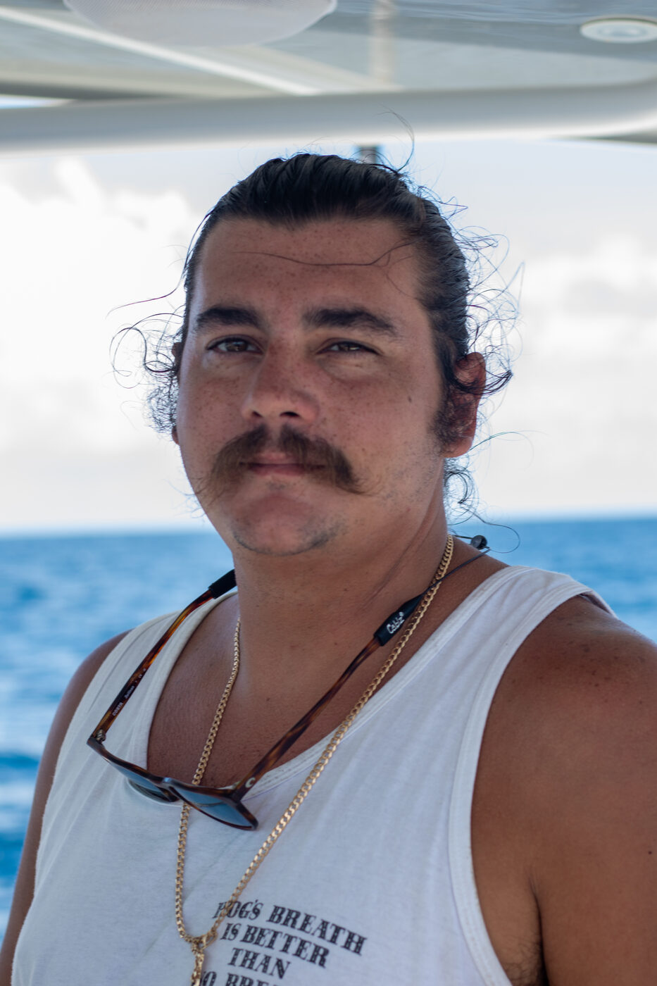 Portrait of a 1776 Charters crew member aboard the boat in the Gulf