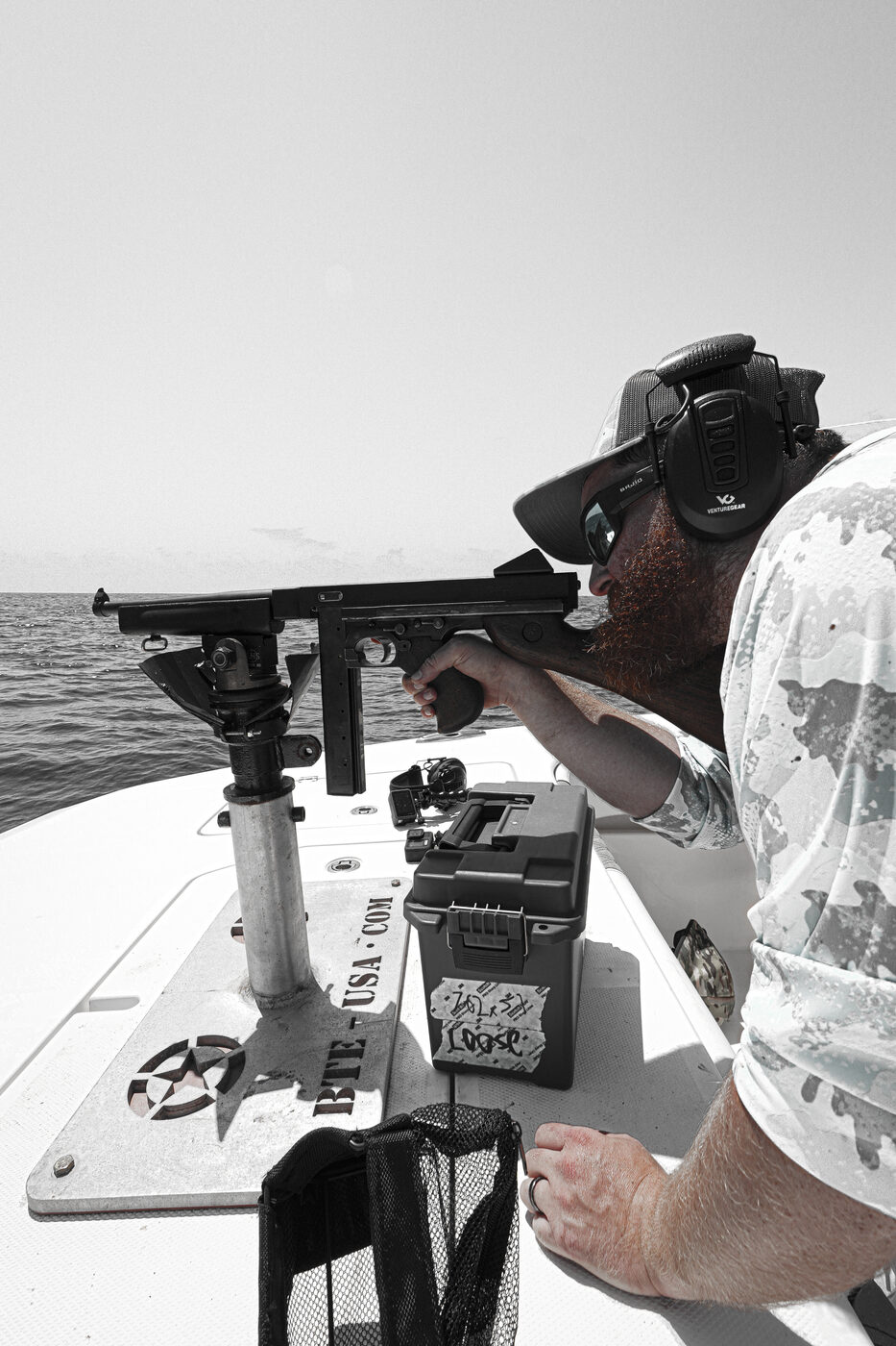Shooter aiming the mounted machine gun out over the open water offshore