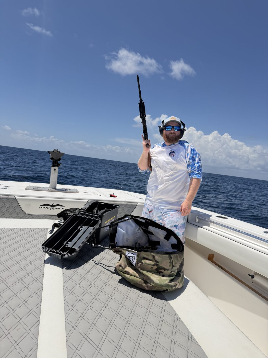 Guest raising a rifle overhead aboard 1776 Charters offshore