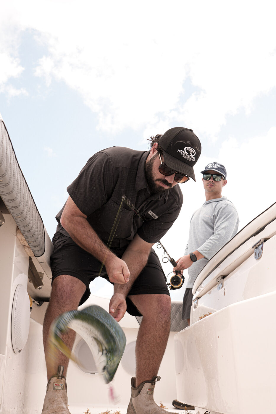 1776 Charters captain rigging a reel on the deck before a drop offshore