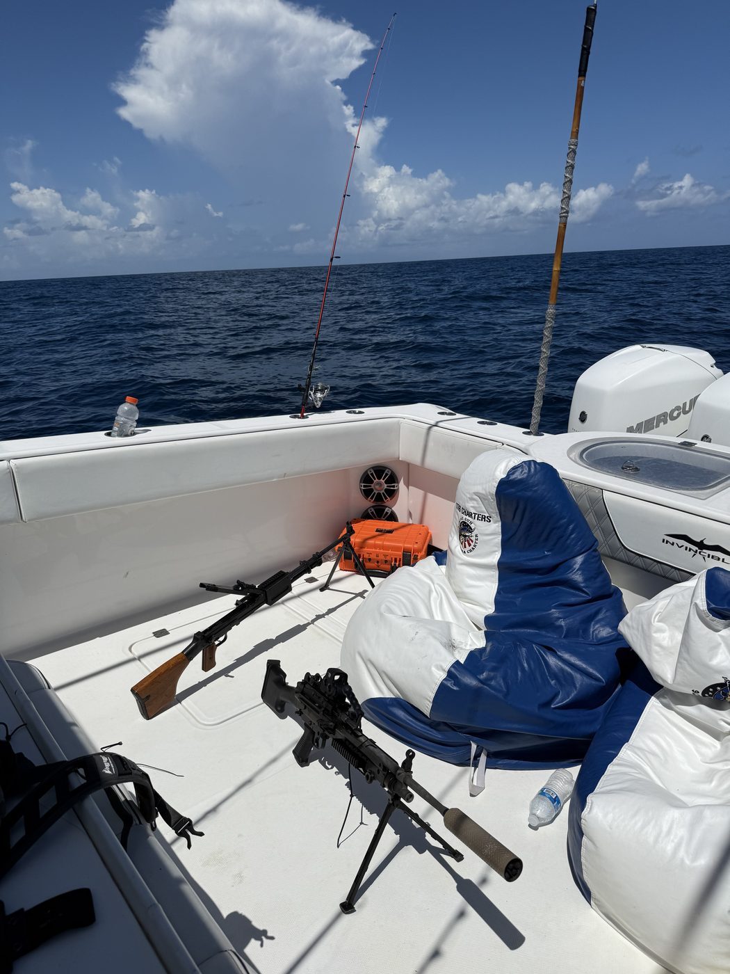 Mounted gun with the quad Mercury outboards and helm seats of the 1776 Charters boat behind